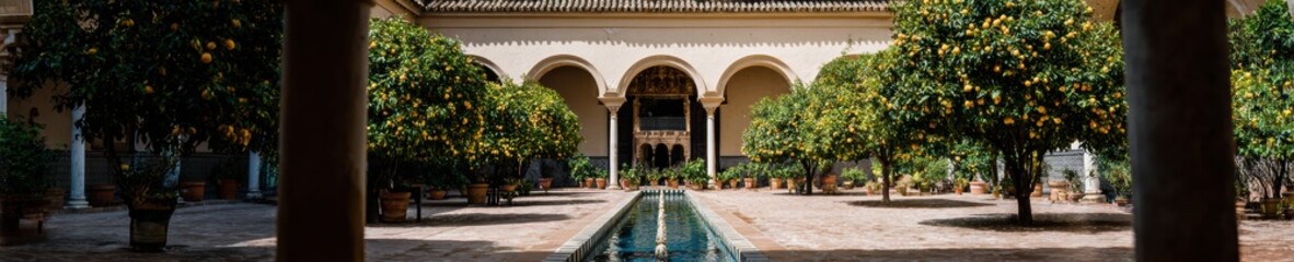 Fototapeta premium Authentic Moorish Alcazar of Seville Courtyard with Ornate Arches and Citrus Trees Premium Cultural Travel Content for Inspiring Marketing Campaigns