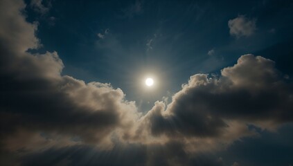 Shining bright sun piercing billowing cumulus clouds in open sky, creating light and shadow