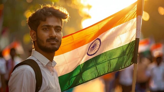Young man proudly holds the Indian flag outdoors in the sunlight, celebrating national pride and patriotism.