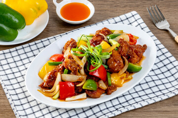 Crispy fried chicken, sweet and sour on the wooden table