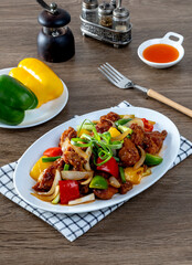 Crispy fried chicken, sweet and sour on the wooden table