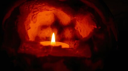 Igniting small tealight candle lighting stone alcove for warm glow, with flickering shadows dancing - Powered by Adobe