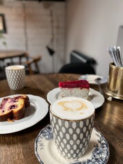 Coffee and cake on wooden table in cozy cafe setting with decorative tableware