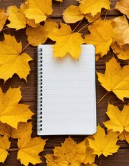 open notebook on wooden table. yellow leaves around. autumn, plans, diary, study.
