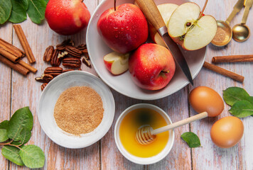 Baking ingredients for apple dessert on wooden table