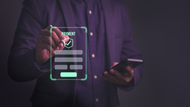 Person using a pen to interact with a payment interface while holding a smartphone, symbolizing secure digital transactions, fintech innovation, online payment systems, and financial technology.