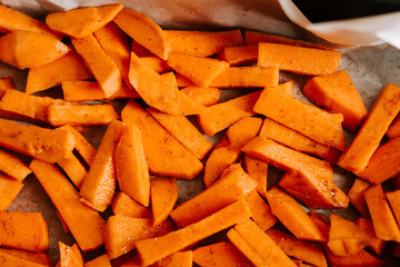 Sweet potatoes sliced and prepared for baking in the oven
