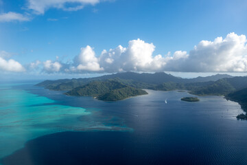 Naklejka premium Aerial view of Tahaa island, French Polynesia, with turquoise lagoon and reef