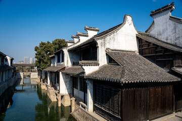 Serene Riverside Architecture Showcasing Traditional Homes and Tranquil Waterscape