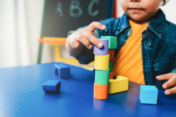 Kid playing with wood toys at pre school classroom. Kindergarten education smart games for children