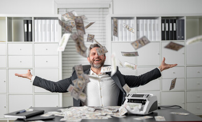 Handsome businessman throwing dollar bills in the air with excitement. Successful man throwing falling cash. Rich business man throwing dollar bills. Handsome man throwing cash while money.