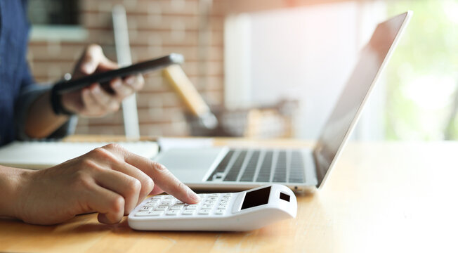 close up accountant businessman accountant hand use calculator to calculate about profit and budget on project for business and financial concept