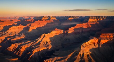 Aerial view of grand canyon at sunset showcasing layered rock formations and shadows in arizona desert