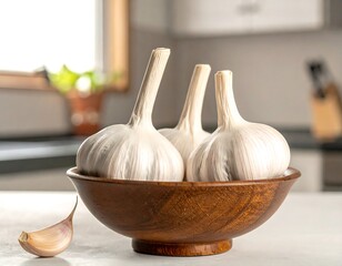 Three whole bulbs of pungent allium in a wooden bowl with a single clove resting next to it on a white countertop