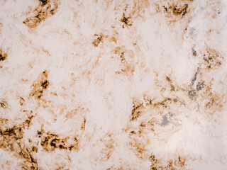 Golden tan marble texture background with swirling organic veins