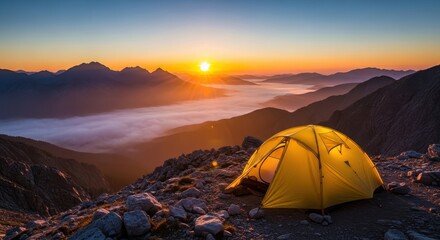 Yellow tent on mountain peak enjoying stunning sunset scenery