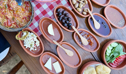 Terracotta dishes cradle vibrant Mediterranean delights, echoing the indulgence of Meze Day, flavors dancing like a Zorba's embrace