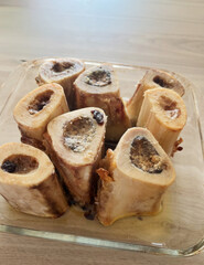 Rustic roasted marrow bones, culinary delight for ancestral diets, paleo feasting, nourishing winter solstice traditions, primal indulgence tableau