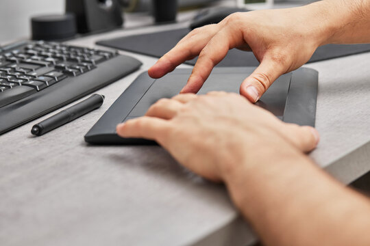 male hands drawing and retouching image on pc computer, using graphic digital tablet and stylus pen, finger touching on screen - Powered by Adobe