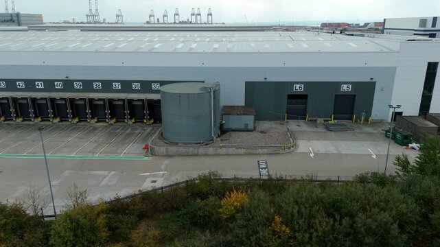 Aerial  close up drone view of industrial warehouse factory loading bay doors 