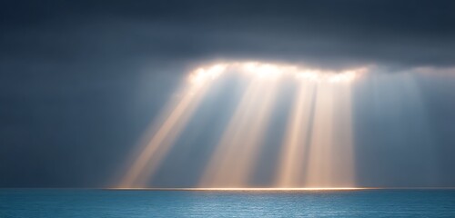 Golden beams shining through clouds horizon above wide ocean