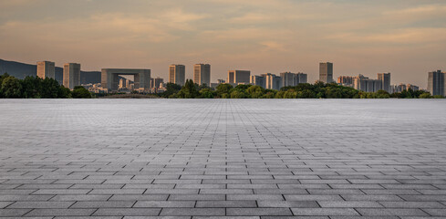 Urban Landscape with Paved Foreground and City Skyline at Dusk