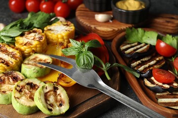 Vegetarian barbeque. Tasty grilled vegetables served on grey table, closeup