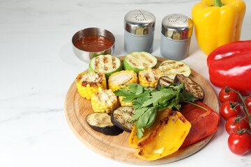 Vegetarian barbeque. Tasty grilled vegetables served on white marble table, closeup. Space for text