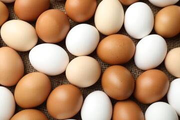 Many raw chicken eggs on table, top view