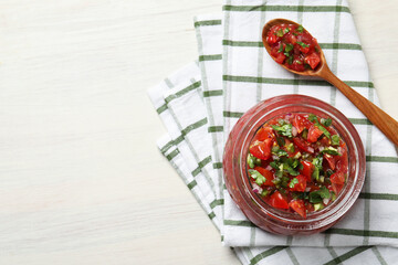 Tasty salsa in jar on white wooden table, top view. Space for text