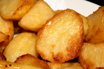 Close up of roasted vegetables crsipy potatoes side dish for Sunday roast dinner