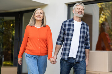Mature male and female family smiling holding hands on residential porch