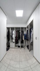 Organized walk-in closet with light gray cabinets