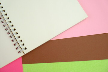 blank paper next to school tools with no word as a template for text space concept. business and education concept. pink background