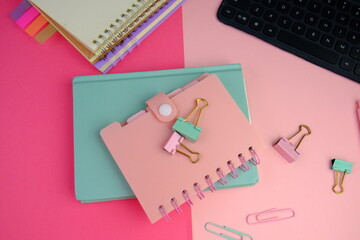 blank paper next to school tools with no word as a template for text space concept. business and education concept. pink background