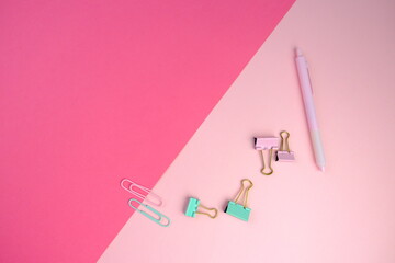 blank paper next to school tools with no word as a template for text space concept. business and education concept. pink background