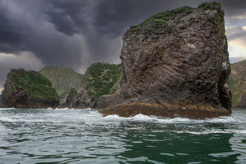 Rocky ocean shore during a thunderstorm