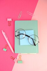blank paper next to school tools with no word as a template for text space concept. business and education concept. pink background