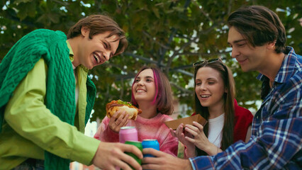 Group of friends laughing and cheering with colorful drinks and street food. Concept of friendship, youth lifestyle, celebration for beverage branding, nightlife campaigns, and social media visuals.