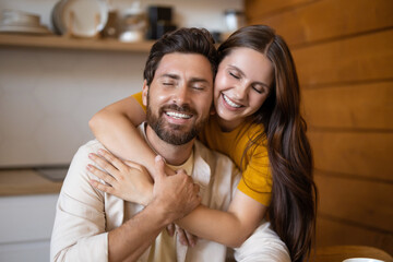 Fototapeta premium Cute couple looking peaceful and happy in the morning at their kitchen