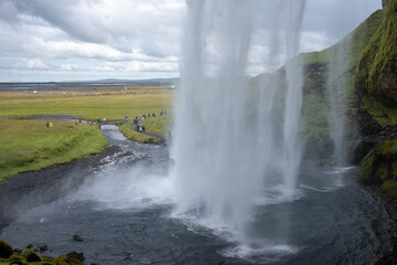 View from behind Seljalandsfoss Waterfall, an iconic attraction on the South Coast of Iceland