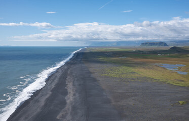 A black sand beach and coastline seen to the west of the Dyrholaey peninsula in Iceland