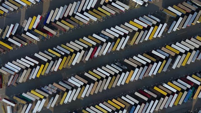 Top down aerial view of shipping freight containers aligned in rows at shipping port in Tilbury near London, United Kingdom 