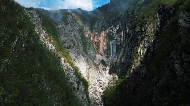 Stunning aerial footage of the tall waterfall on the side of the mountain, Boka