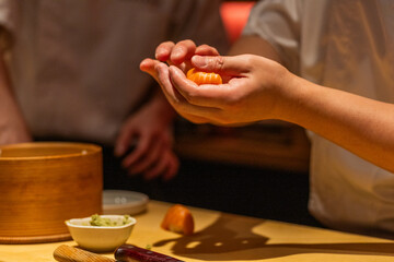 Skilled chef preparing sushi with fresh ingredients in a vibrant kitchen