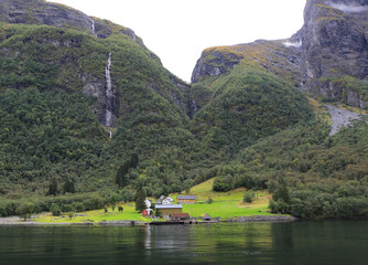 Colorful Wooden Houses with Pier by the Fjords and Waterfall in Gudvangen, Norway