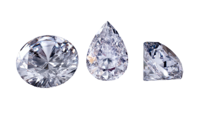 Three dazzling, clear, cut gemstones are shown in round, pear, and half-moon shapes against black
