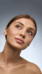 Woman with surgery markings looking upward with gentle hope and self-confidence. Concept of...