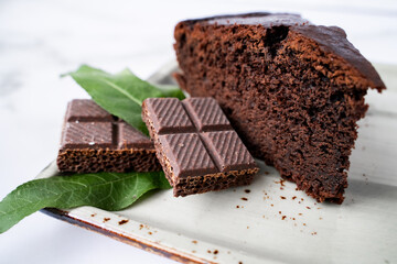 Chocolate cake dessert on ceramic plate on marble table close-up
