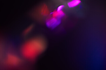 Blurred Light painting one exposure in camera. light glares with a spectral gradient on a dark background.